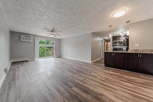 A spacious room with wood flooring and a ceiling fan. at Integrity Berea Apartments, Berea, Ohio