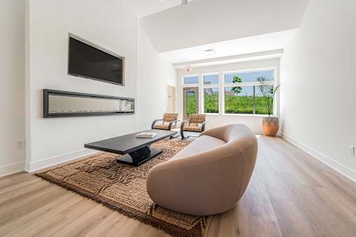 A modern living room with a brown chair and a black coffee table.