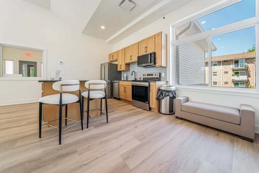 A kitchen with a dining table and chairs.