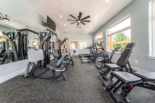 A spacious home gym with a variety of exercise equipment.