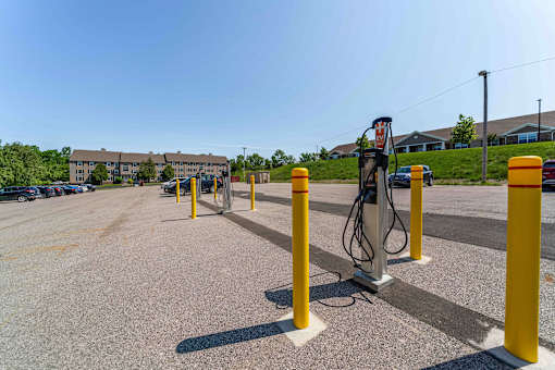 A parking lot with a charging station for electric vehicles.