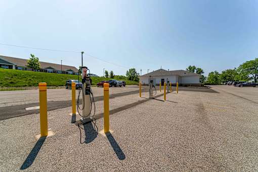 A parking lot with a charging station for electric vehicles.