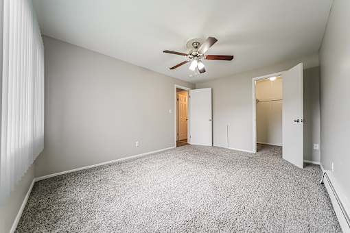 Bedroom with walk-in closet and carpeted floor at Integrity Chardon Apartments, Chardon
