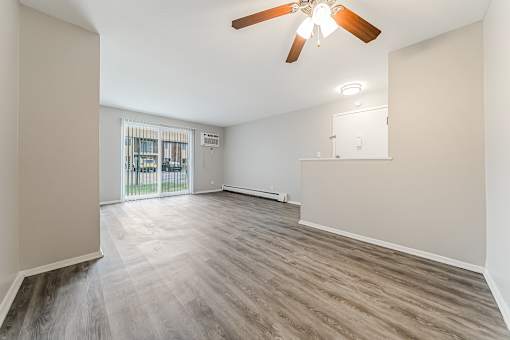 A room with a ceiling fan and wooden flooring at Integrity Chardon Apartments, Chardon