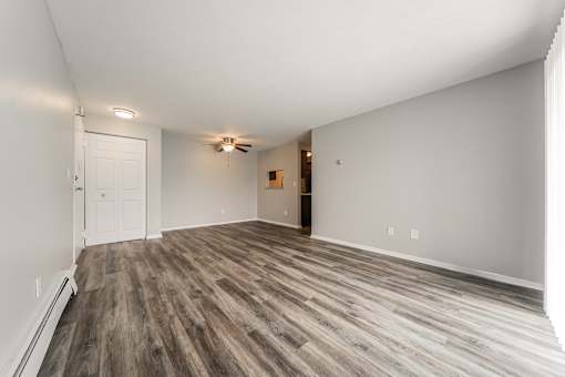 Living room with a wooden floor and a ceiling fan at Integrity Chardon Apartments,Ohio