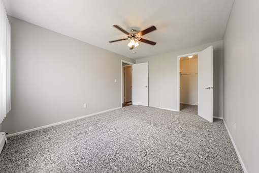Bedroom with a ceiling fan and carpeted floor at Integrity Chardon Apartments, Chardon, 44024