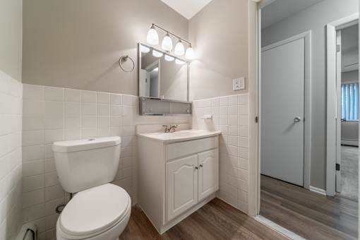 A white toilet sits next to a sink in a bathroom.