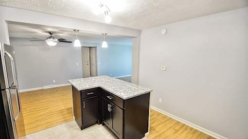 A kitchen with black cabinets and a wooden floor. at Integrity Berea Apartments, Ohio, 44017