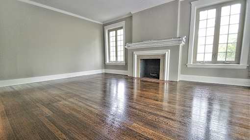 Living room with a fireplace and hardwood flooring at Integrity Gold Coast Apartments, Cleveland, OH, 44102
