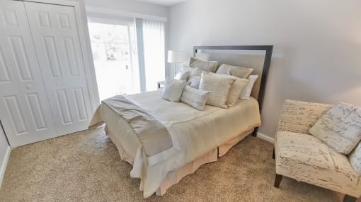Townhome bedroom with large closet and patio access.