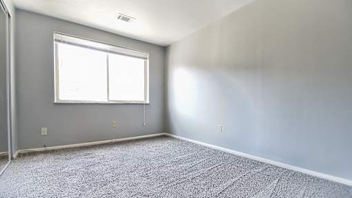 A room with a carpeted floor and a window. at Integrity Berea Apartments, Berea, 44017