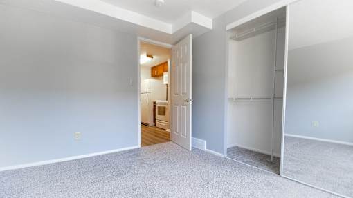 A room with a white door and a grey carpet. at Integrity Berea Apartments, Berea, Ohio