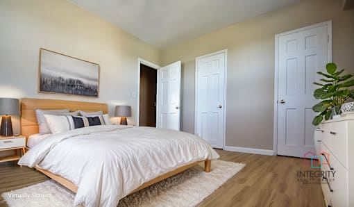 A bedroom with a large bed and a painting on the wall Integrity Realty, Cleveland, OH, 44120