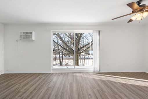 Updated Wynwood living room with sliding glass door to balcony.