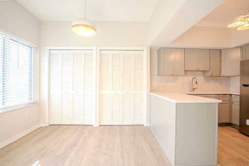 A kitchen with a white island and wooden floors t Atrium in The Village, 44122