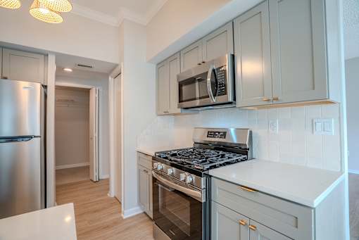 A kitchen with a stove, microwave, and refrigerator t Atrium in The Village, Beachwood, OH 44122