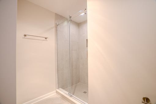 A white bathroom with a glass shower door t Atrium in The Village, Beachwood, OH 44122