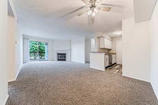 Carpeted living area with updated kitchen. at Hunt Club Apartments, Copley, Ohio