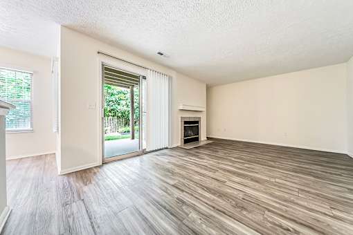 Updated living room with plank-style flooring at Hunt Club Apartments, Ohio