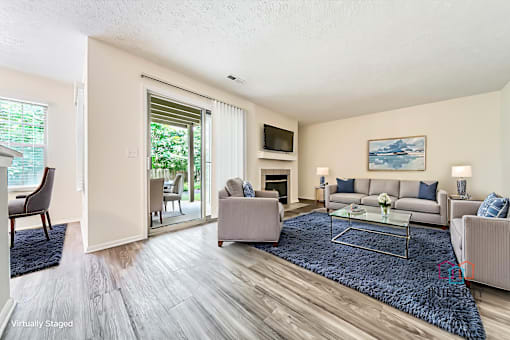 Updated living room with plank-style flooring and example furnishings at Hunt Club Apartments, Copley