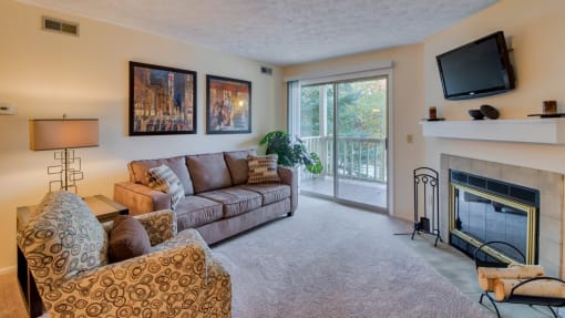 Furnished carpeted living room at Hunt Club Apartments, Copley, OH