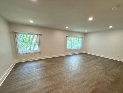 A room with wooden flooring and two windows Old Green Place Apartments, Beachwood, OH