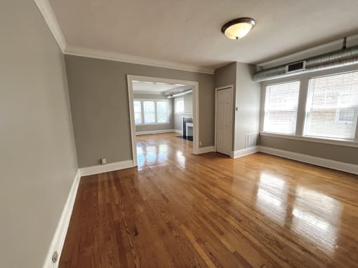 Living room with wood floors and windows at Integrity Cleveland Heights, Cleveland Heights, 44106