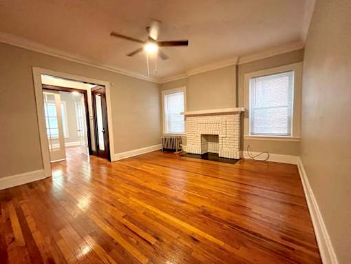 A room with a fireplace and wood flooring. at Integrity Cleveland Heights Apartments, Ohio, 44106