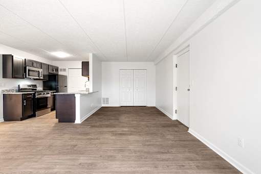 A kitchen with dark brown cabinets and white walls at Integrity Medina Apartments, Medina, OH,  44256
