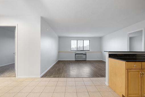 A kitchen area with a black countertop and wooden cabinets at Integrity Medina Apartments, Medina, OH,  44256