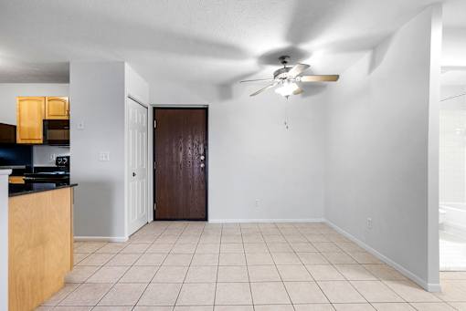 A room with a ceiling fan and a brown door at Integrity Medina Apartments, Medina, OH,  44256