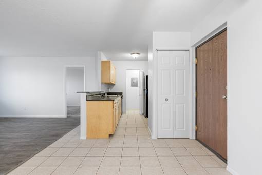 A kitchen with white walls and a wooden door at Integrity Medina Apartments, Medina, OH,  44256
