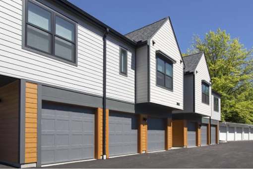 A modern house with a grey and brown exterior and a black roof.