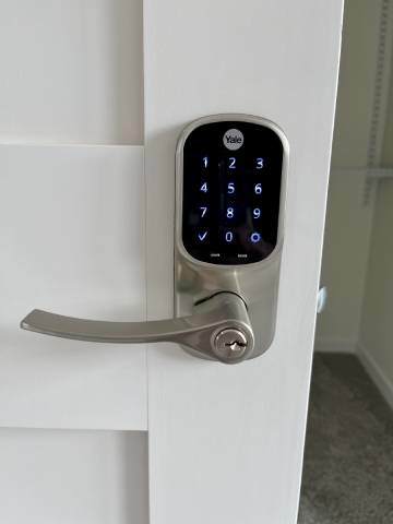 A keypad is attached to a door handle.