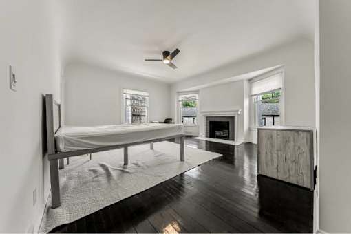 A spacious bedroom with a large bed and a fireplace.