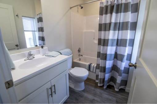 A bathroom with a toilet, sink, and shower.