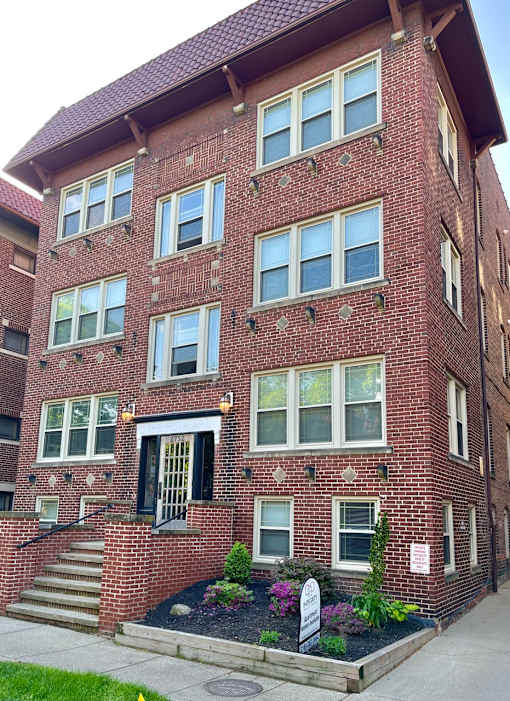 A red brick building with a black door and windows. at Integrity Cleveland Heights Apartments, Apartments, Cleveland Heights, OH