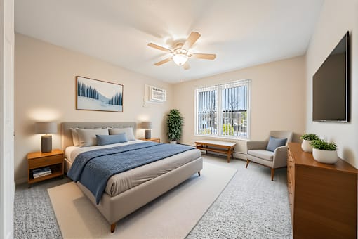 A bedroom with a large bed and a ceiling fan.