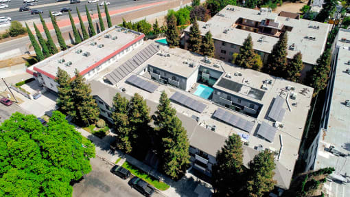 Aerial drone image of building with view of solar panels.