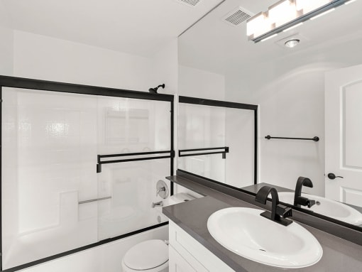 White bathroom with modern fixtures, shower, and tub.