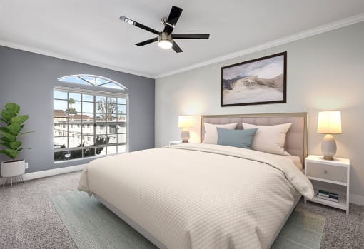 Carpeted bedroom featuring beautiful natural lighting and ceiling fan.