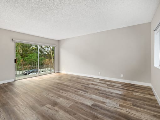 Hardwood floored bedroom with direct balcony access.
