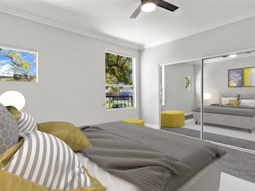 Carpeted bedroom with ceiling fan.