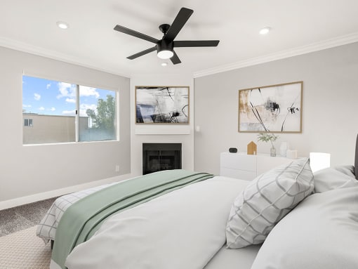 Carpeted bedroom with ceiling fan and private fireplace.
