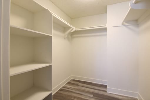 Walk in closet with ample storage, shelves, and hanging rods.