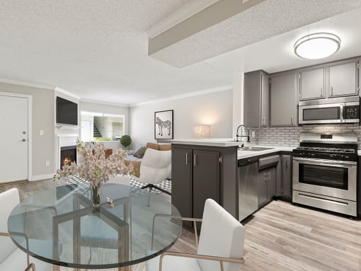 Dining room with hardwood floor and view of kitchen and living room.