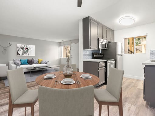 Dining room with hardwood floor and view of living room and tiled and stainless steel kitchen.
