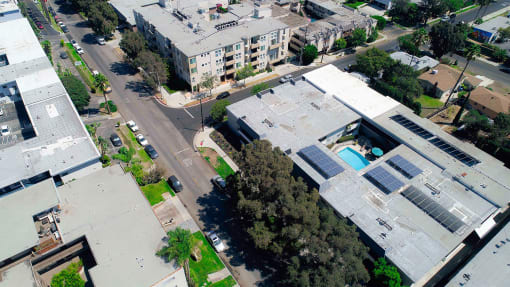 Aerial drone image of Rose Apartments and courtyard with pool.