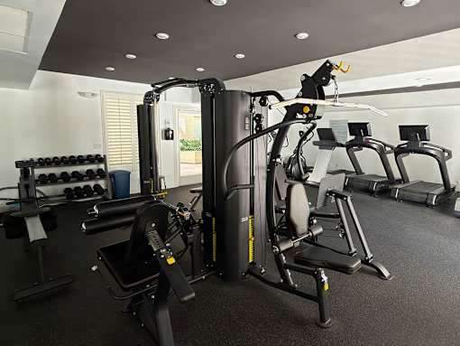 Fitness Center with Weight Machines, Treadmills, and Bikes.