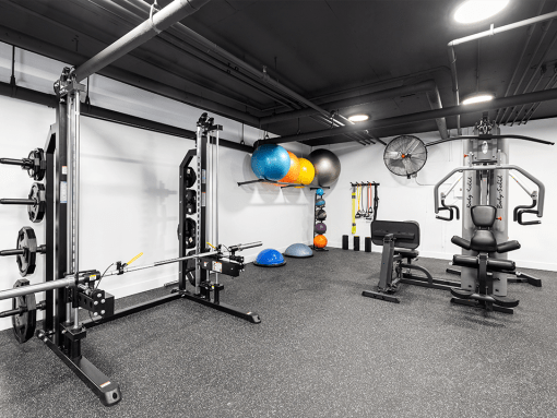 Fitness center Including cycling bikes, ellipticals, treadmills, free weights, and stretching balls.